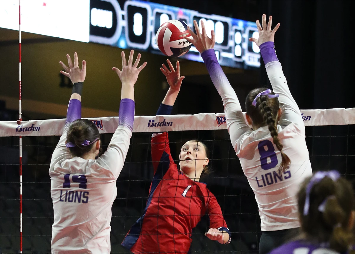 Viterbo University Volleyball player blocking 